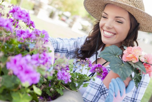Gardener with tools on a well-kept lawn representing insured gardening services